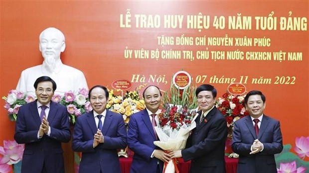 President Nguyen Xuan Phuc receives a 40-year Party membership badge