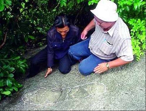 Architect Vo Xen carefully examines the sacred footprints on Co To Mountain which are said to have existed for centuries