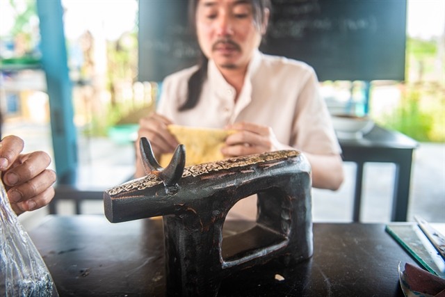 An artist creates a lacquer from driftwood. It is a 'green' and sustainable tourism destination in the town. — Photo courtesy of Lê Ngọc Thuận