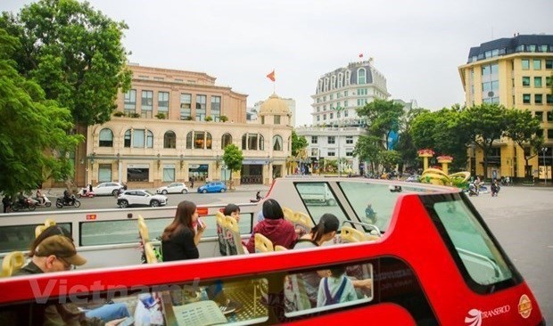 Visitors on a double-decker bus tour around Hanoi. (Source: Vietnam Plus)
