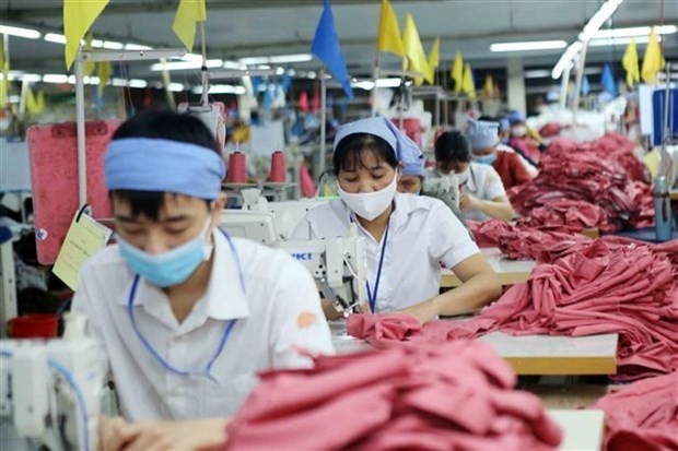 Workers make garments for exports at a factory in Vietnam. (Photo: VNA)