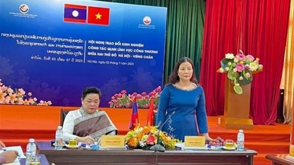 Hanoi, Vientiane share experience in State management in industry, trade