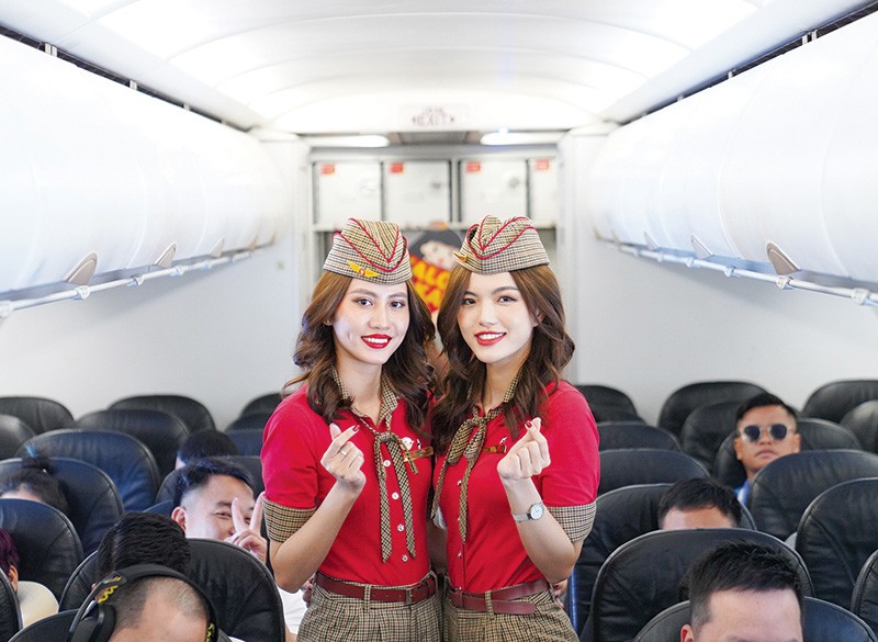 Vietjet’s cabin crews welcome passengers on board. Vietjet’s cabin crews welcome passengers on board.