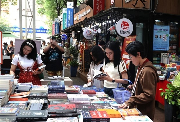 Young readers read their favourite books at HCM City Book Street on Nguyen Van Binh street in District 1. (Photo: VNA)