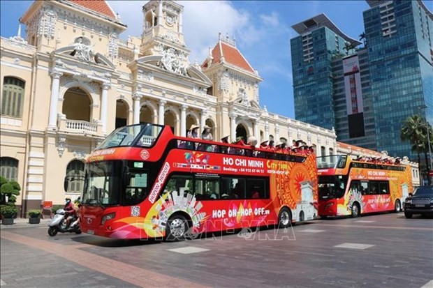 Tourists join a city tour in HCM City (Photo: VNA)