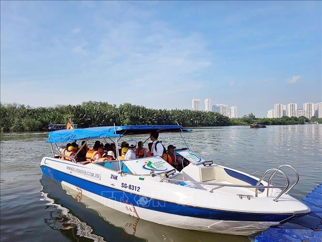Visitors join waterway tour in HCM City  (Photo: VNA)