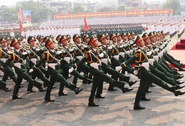 Military forces parade past the grandstand at the rehearsal. (Photo: VNA)