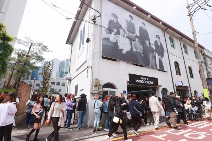 A bustling crowd of fans wait in line for a BTS pop-up store in eastern Seoul's Seongsu-dong, April 26. Yonhap A bustling crowd of fans wait in line for a BTS pop-up store in eastern Seoul's Seongsu-dong, April 26. Yonhap