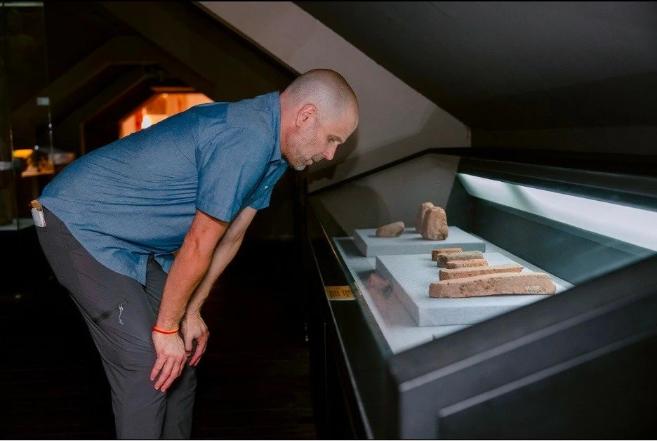 Assoc. Prof. Shannon Gramse gazes upon artifacts from centuries past. Assoc. Prof. Shannon Gramse gazes upon artifacts from centuries past.