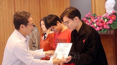 Ho Chi Minh City presents health insurance cards to impoverished people for Tet