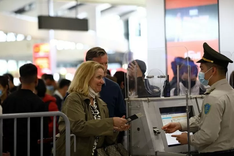 An aviation security official checks passenger information before security screening. (Source: VNA)