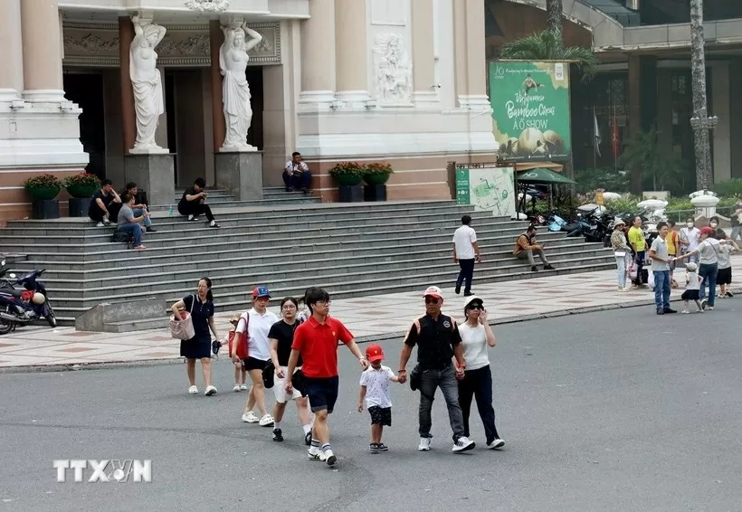 Visitors stroll around Lam Son Square in front of the Ho Chi Minh City Opera House. (Photo: VNA)