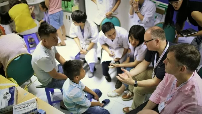 Doctors from the UK charity Facing The World (FTW) conduct screenings for pediatric patients at Viet Duc University Hospital during their 2018 mission. (Photo courtesy of FTW)