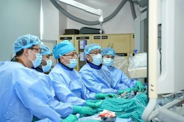 Surgeons at the HCM City University Medical Centre perform a TAVI procedure. ( Photo courtesy of the hospital) Surgeons at the HCM City University Medical Centre perform a TAVI procedure. ( Photo courtesy of the hospital)