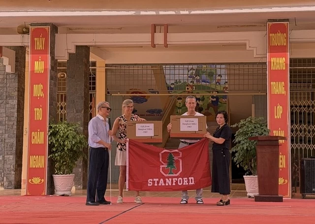 Representatives from Stanford Business School donated computers to the school