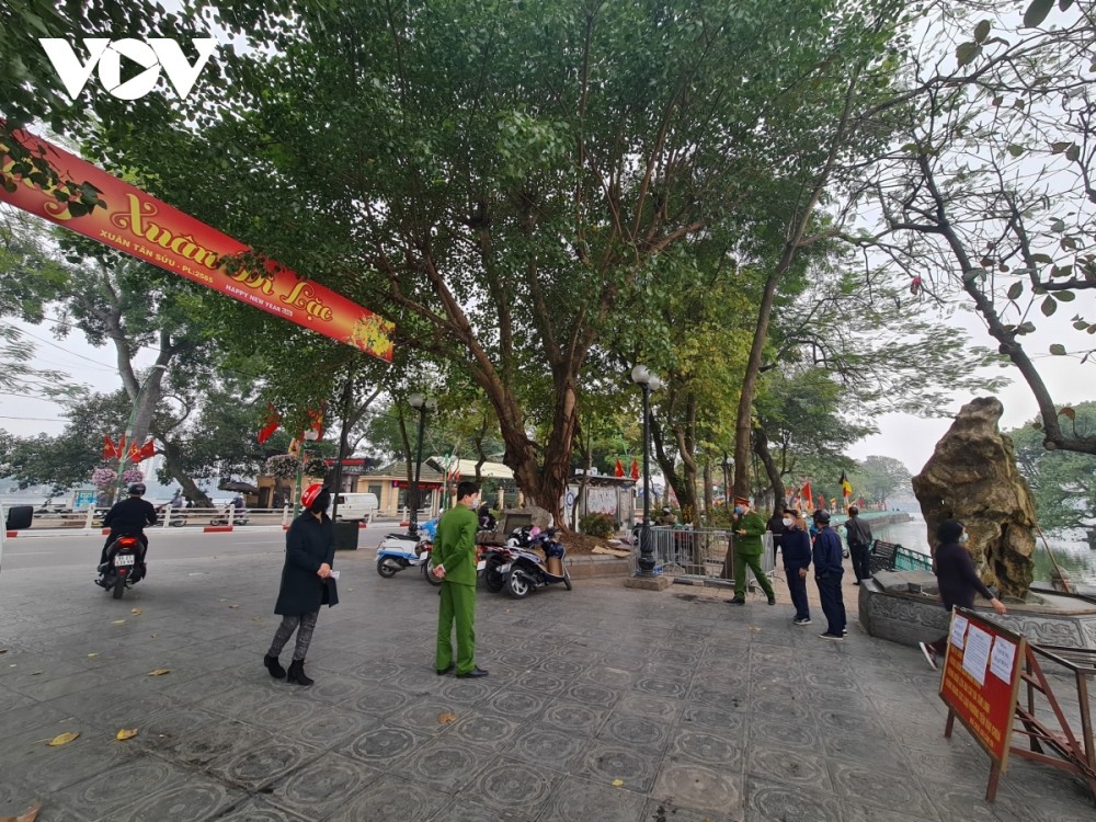 Policemen are on duty in order to warn people about not gatherings in front of Tran Quoc pagoda.