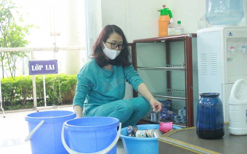 A teacher disinfects all cups at Xuan Phuong primary school located in Nam Tu Liem district, one of the capital’s recent COVID-19 hotspots.