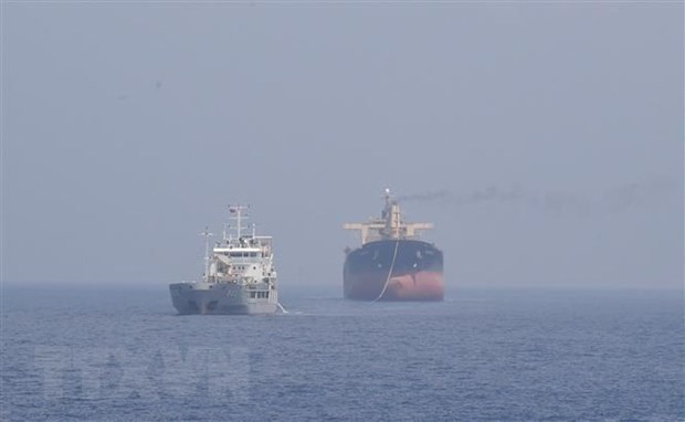 Panamanian vessel Pacific 07 (right) is being tugged to a location near Song Tu Tay Island for repair. (Photo VNA)