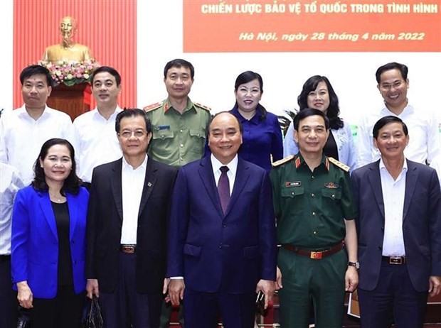 President Nguyen Xuan Phuc and delegates at the meeting pose for a group photo. (Source: VNA)