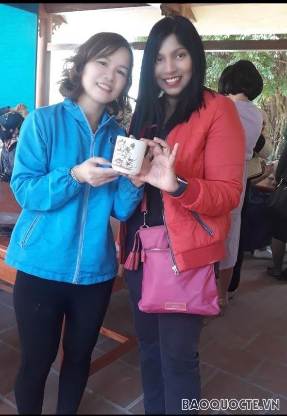 Sujatha Ramachandra (right) with her self-designed tea cup when visiting Chu Dau pottery production facility in Hai Duong province.