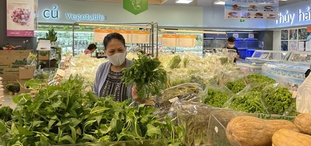 A shopper buys goods at a supermarket in HCM City. (Photo: VNA)