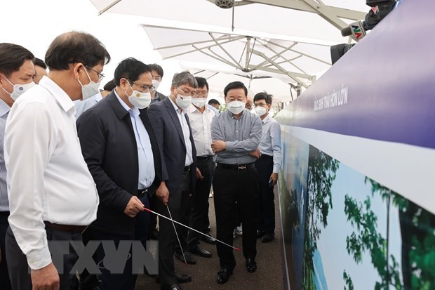 Prime Minister Pham Minh Chinh and officials look at a map of the local development planning while visiting the Van Phong Economic Zone on March 12. 