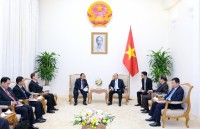 top lao leader receives vietnamese party officials