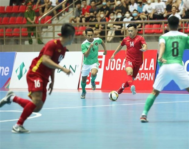 Vietnamese players (in red) in the match against Indonesia on May 11. (Photo: VNA)