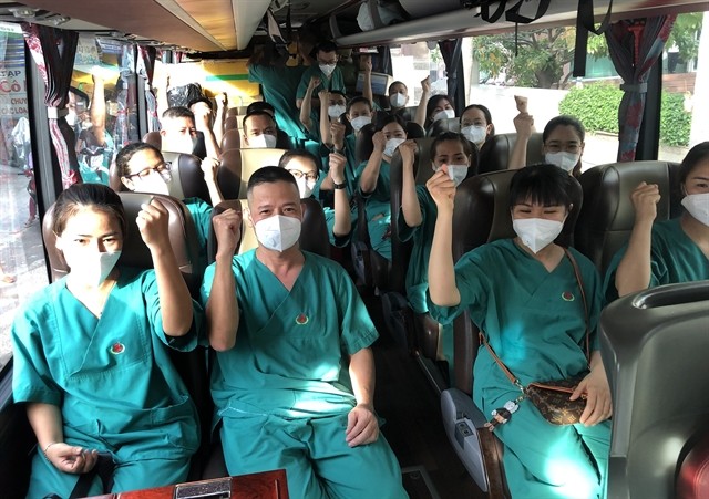 Medical workers from the central-southern province of Bình Định express their determination as they head to HCM City to support COVID-19 prevention and control. — VNA/VNS Photo Nguyên Linh