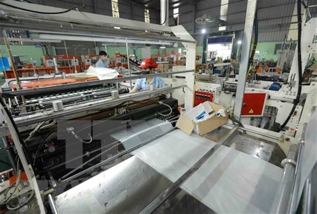 Workers are working on the production line at a plastic bag factory of the HAPLAST JSC (Photo: VNA)
